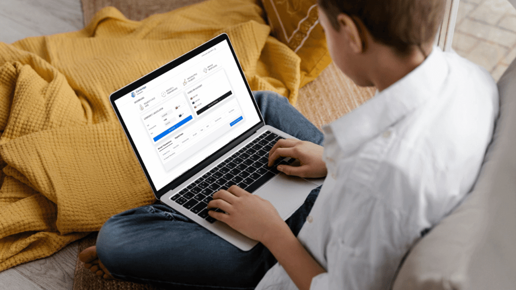 Person sitting comfortably using the Cambridge Currencies platform on a laptop to manage their online banking.
